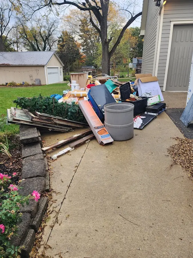 Dumpster being loaded with debris for 12 Yard Dumpster Rental in Upper Yoder